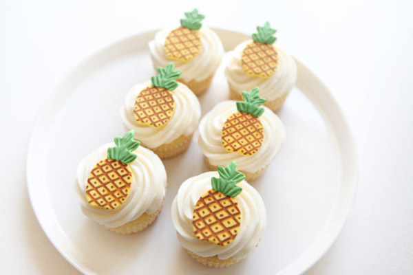 Pineapple Cupcakes and cupcake toppers! - See More Lovely Pineapple Party Ideas At B. Lovely Events!